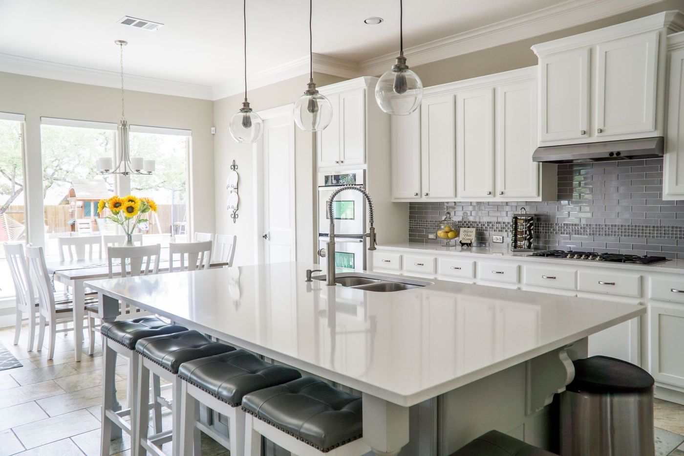 A bright white kitchen and dining area in natural light
